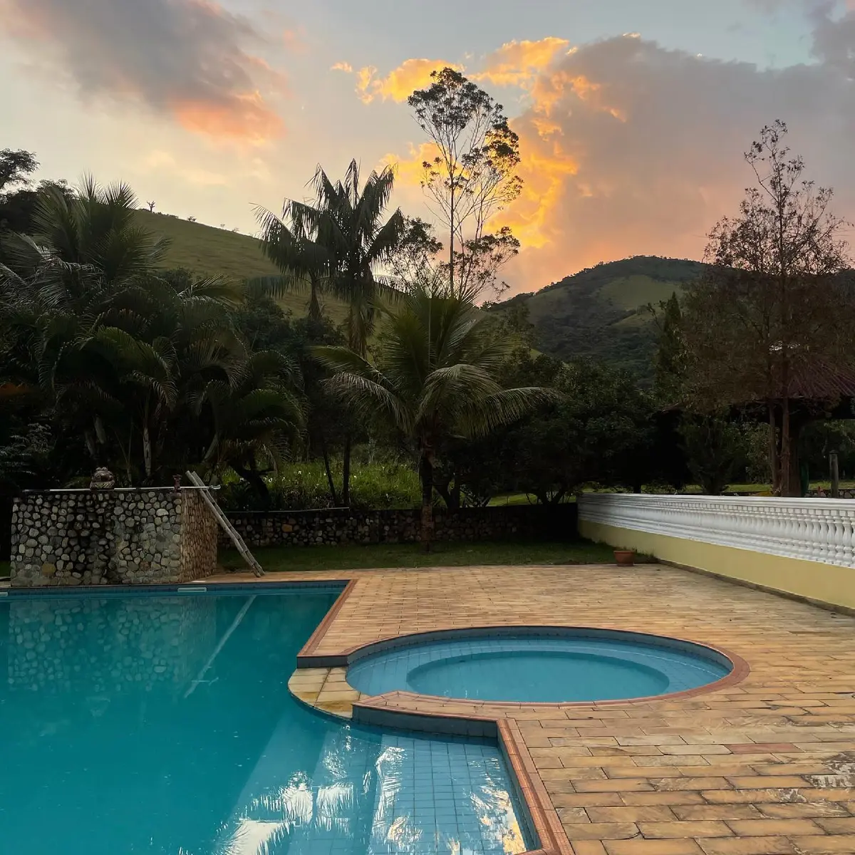 Pool area at Fazenda Neuchatel surrounded by the green of the Paraíba Valley